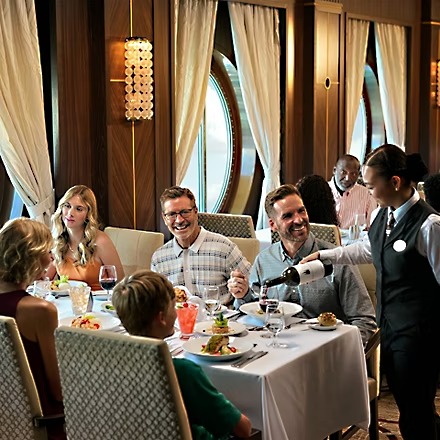 imgi_21_family-dining-at-main-dining-room-while-being-poured-wine-by-server.jpeg